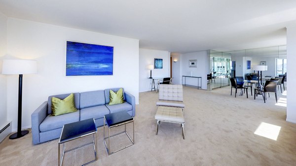 Modern living room with cozy furniture and city views at 1000 Chestnut Apartments