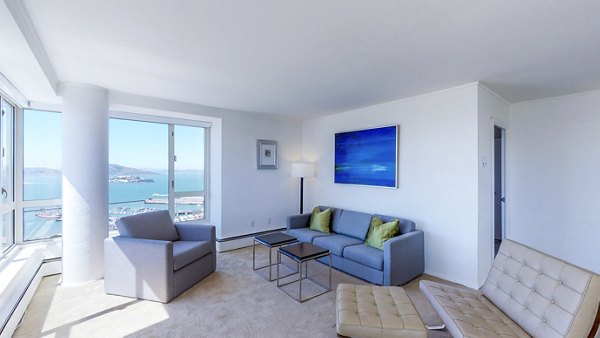 Spacious living room with modern decor and city views at 1000 Chestnut Apartments