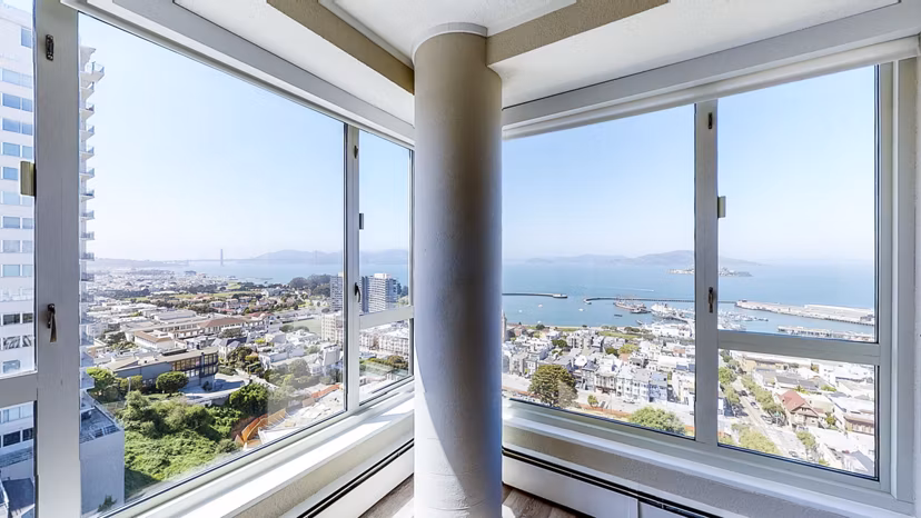 Spacious living room with modern decor in 1000 Chestnut Apartments, offering luxury living in a prime location