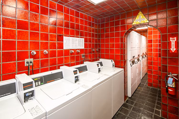 Laundry room featuring modern washers and dryers at 1000 Chestnut Apartments, Greystar luxury property in Chicago