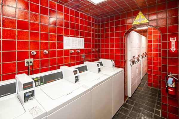 Laundry room featuring modern washers and dryers at 1000 Chestnut Apartments, Greystar luxury property in Chicago