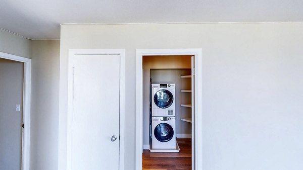 Laundry room with modern washers and dryers at 1000 Chestnut Apartments, a luxury property by Greystar in a prime location