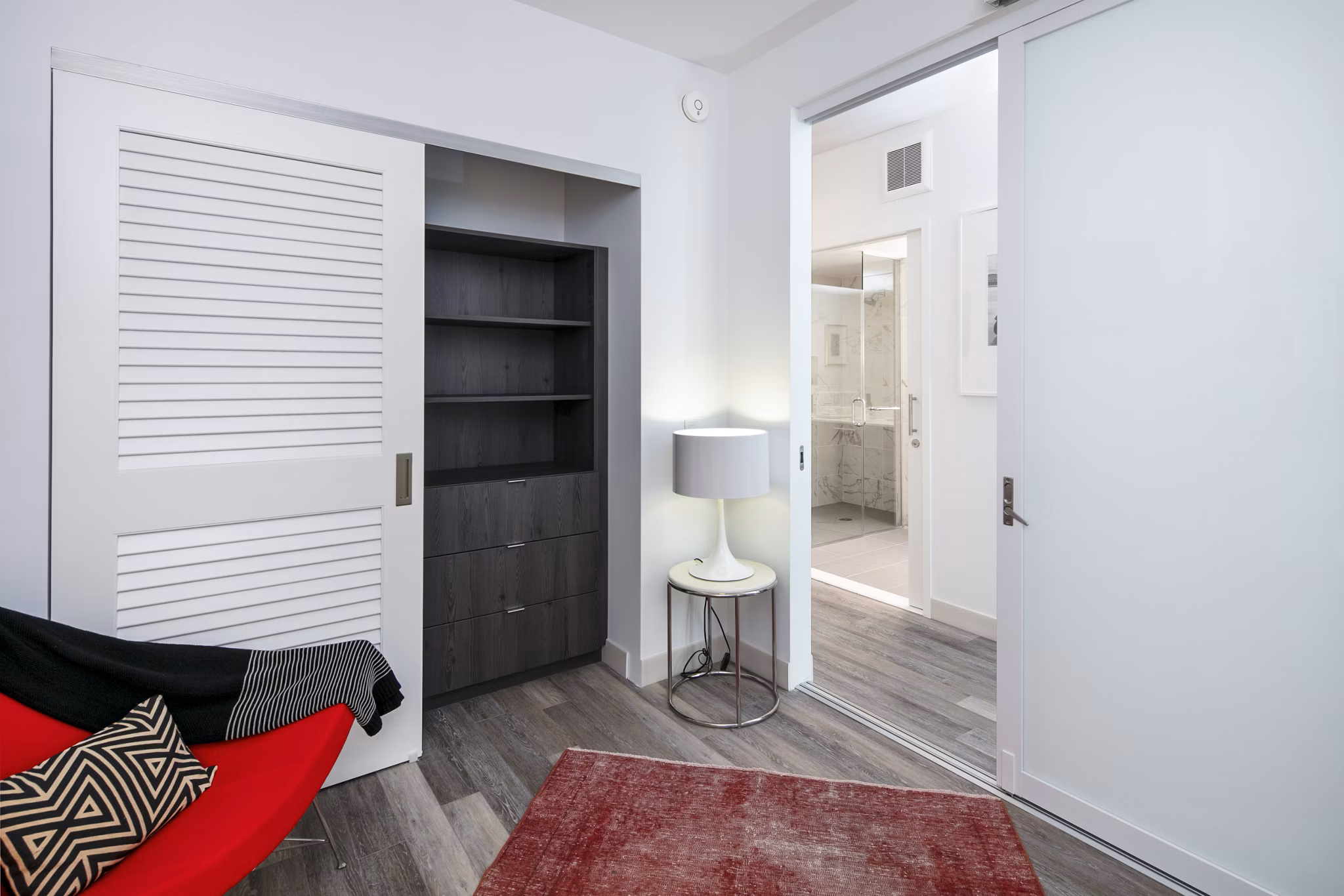 Bedroom with home office nook at 1177 Market Apartments, featuring modern decor and ample natural light