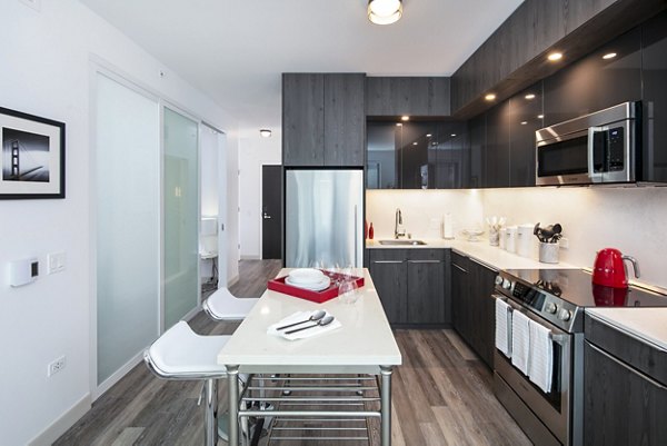 Kitchen and dining room featuring modern appliances and chic decor at 1177 Market Apartments in San Francisco