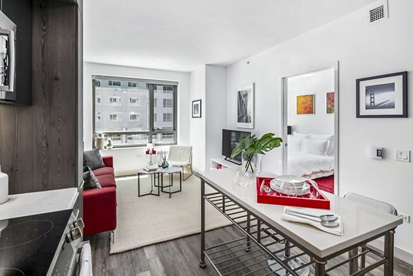 Modern kitchen and dining room with stainless steel appliances at 1177 Market Apartments in a luxury Greystar community