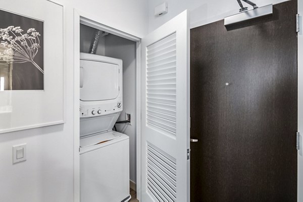 Entry and laundry room with modern appliances at 1177 Market Apartments in San Francisco