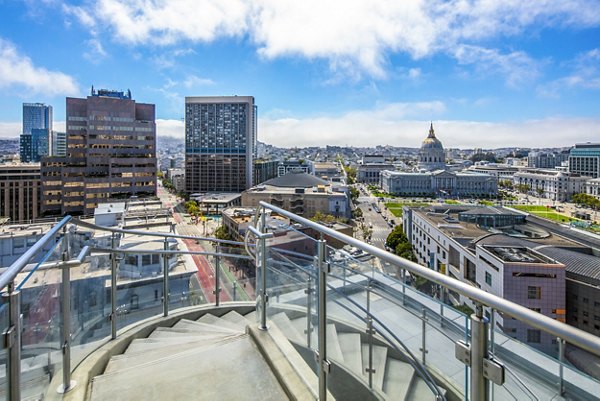 Outdoor patio with modern seating and skyline views at 1177 Market Apartments