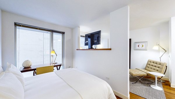 Bedroom with modern decor and ample lighting at 1188 Mission Apartments in San Francisco