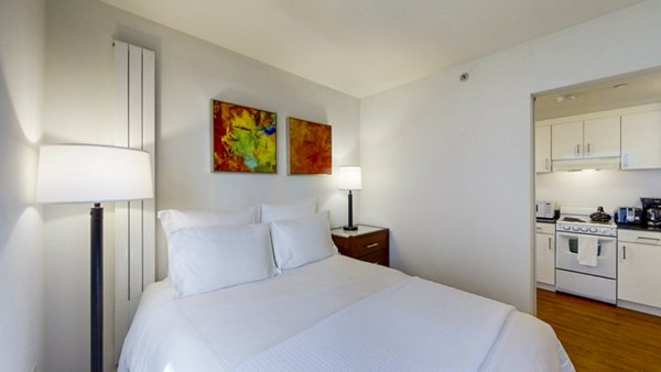 Comfortable bedroom with city views at 1188 Mission Apartments in San Francisco