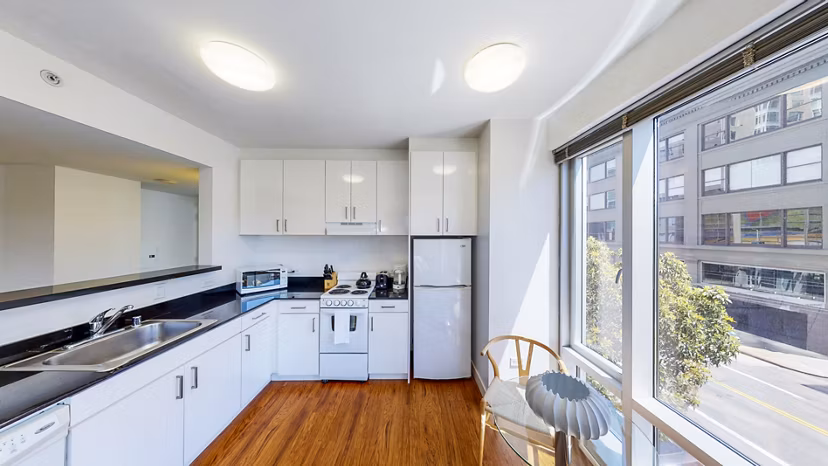 Modern kitchen with sleek appliances and granite countertops in 1188 Mission Apartments, showcasing luxury living in a premier urban location