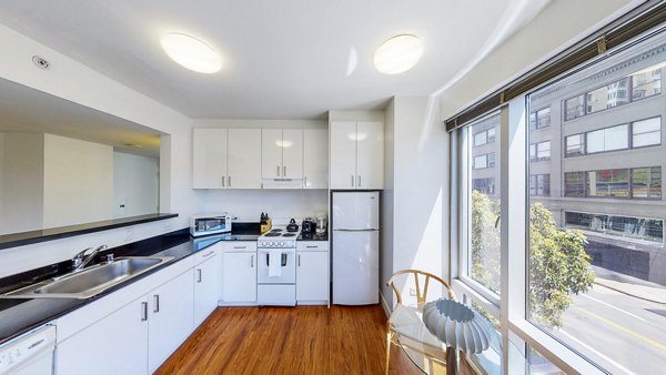 Modern kitchen with sleek appliances and granite countertops in 1188 Mission Apartments, showcasing luxury living in a premier urban location