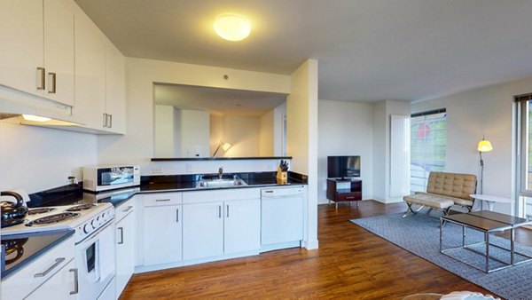 Modern kitchen with stainless steel appliances and granite countertops at 1188 Mission Apartments in San Francisco