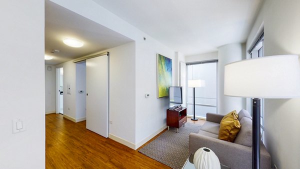 Living room with modern decor and floor-to-ceiling windows at 1188 Mission Apartments in San Francisco