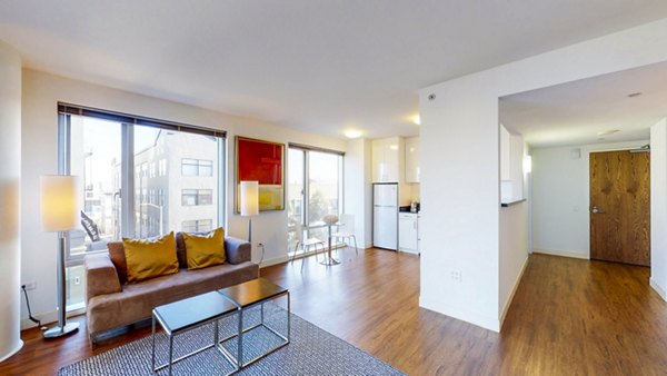 Elegant living room with sleek modern furniture at 1188 Mission Apartments, luxury property under the Greystar portfolio