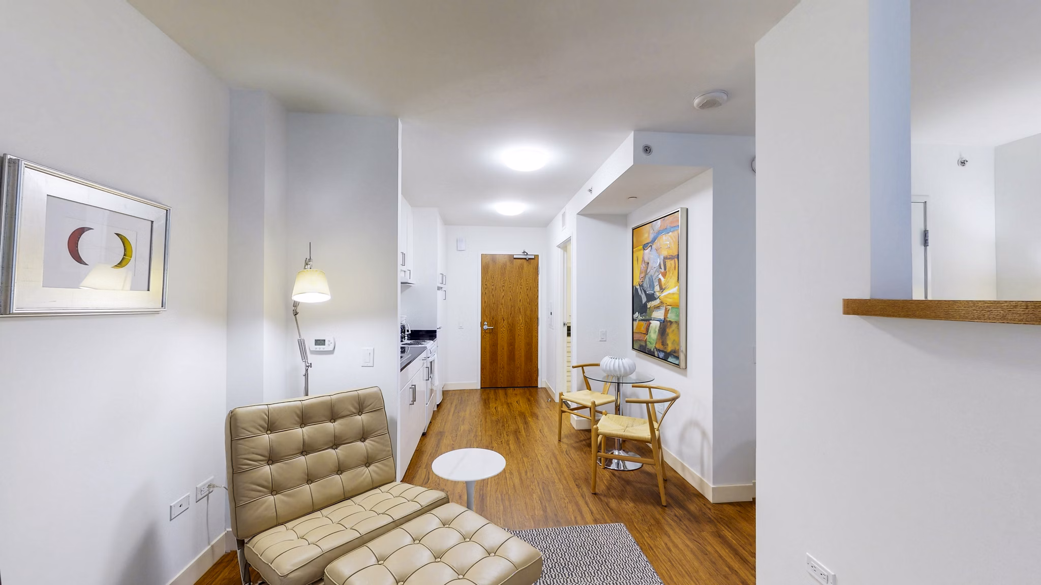 Spacious living room featuring modern decor and large windows at 1188 Mission Apartments