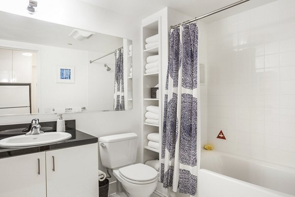 Bathroom featuring modern fixtures and large vanity in 1190 Mission Apartments