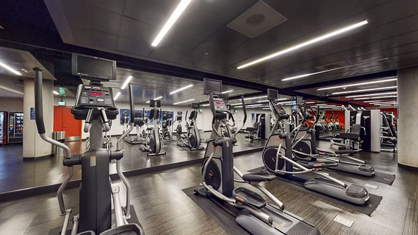 Modern fitness center equipped with advanced workout machines at 1190 Mission Apartments