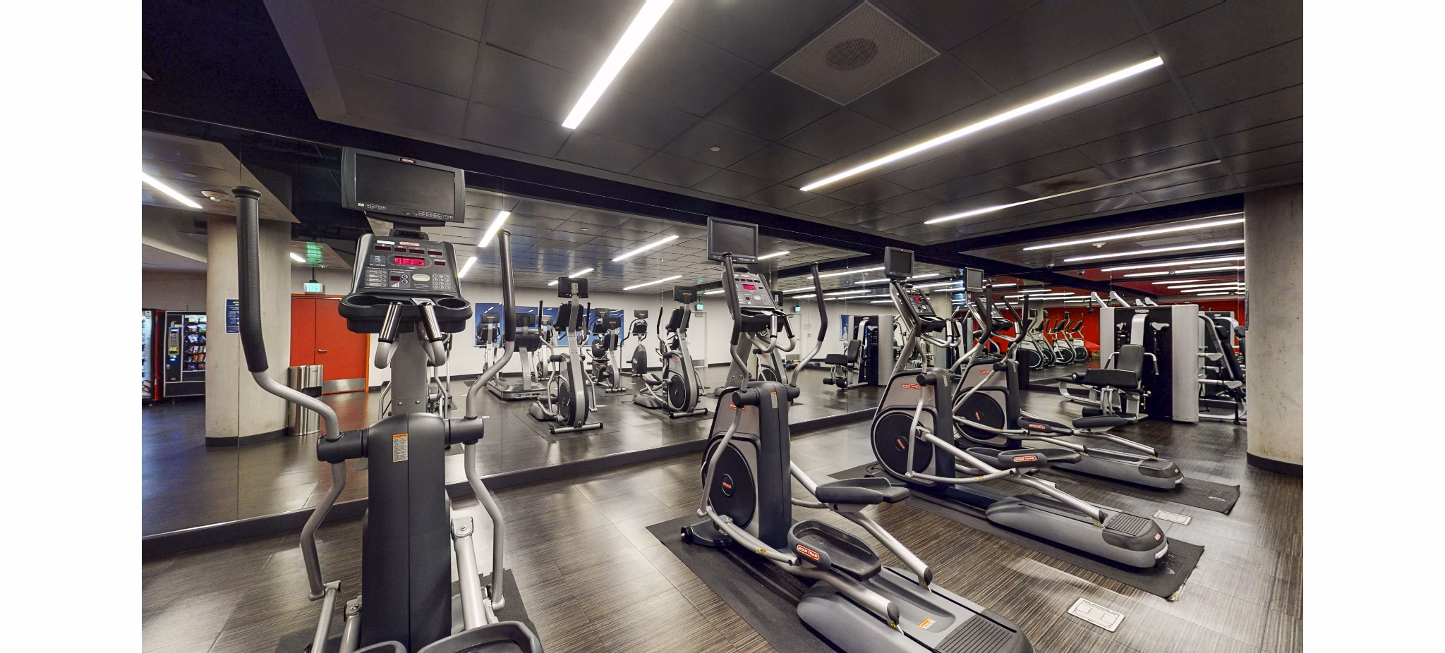 Modern fitness center equipped with advanced workout machines at 1190 Mission Apartments