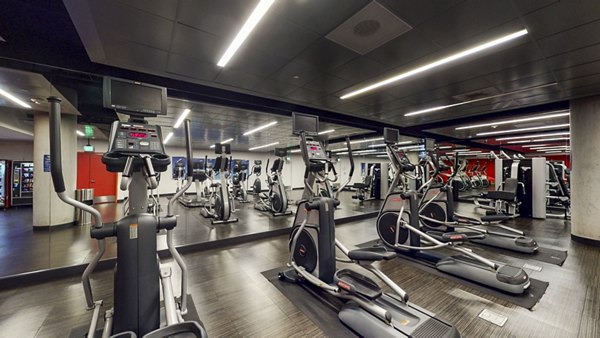 Modern fitness center equipped with advanced workout machines at 1190 Mission Apartments