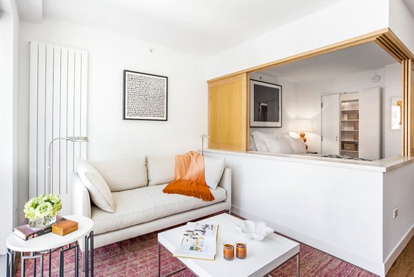 Modern living room with sleek furniture and large windows at 1190 Mission Apartments in San Francisco