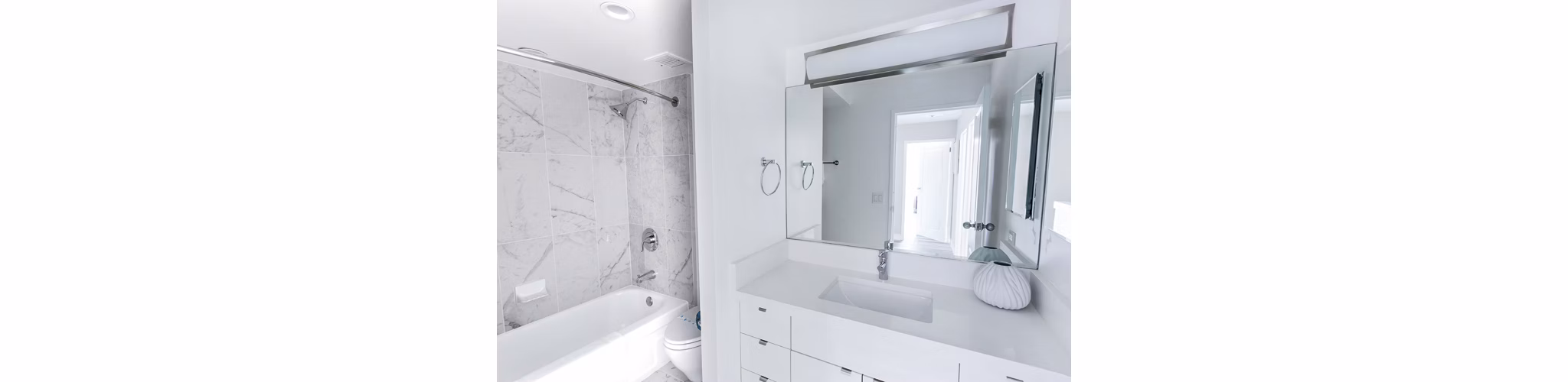 Bathroom featuring sleek fixtures and modern design at 2000 Broadway Apartments, luxury living by Greystar