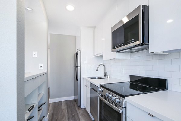 Modern kitchen with stainless steel appliances at 2000 Broadway Apartments