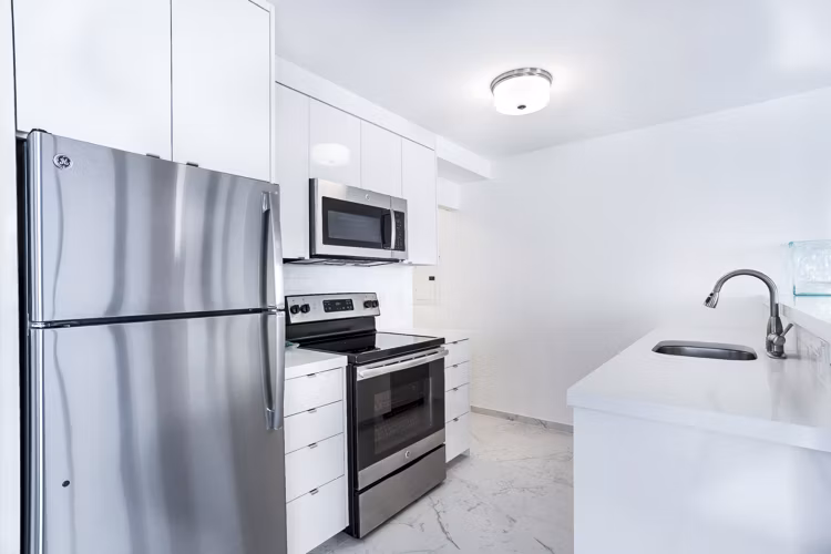 Modern kitchen featuring stainless steel appliances and granite countertops at 2000 Broadway Apartments