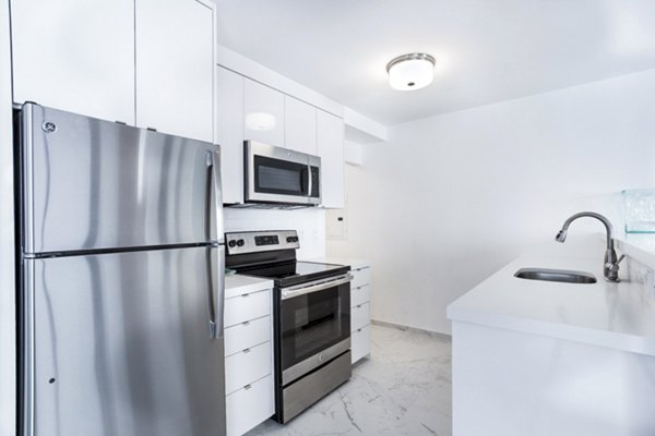 Modern kitchen featuring stainless steel appliances and granite countertops at 2000 Broadway Apartments