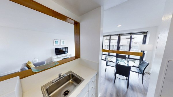 Modern kitchen with stainless steel appliances in 2000 Broadway Apartments