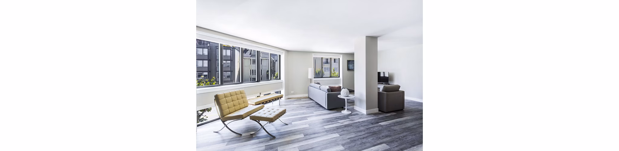 Open-concept living room with stylish decor at 2000 Broadway Apartments, highlighting modern luxury living in a central location