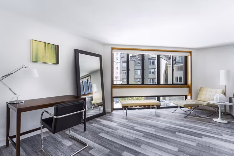 Living room with modern decor and ample natural light at 2000 Broadway Apartments, luxury housing solution by Greystar