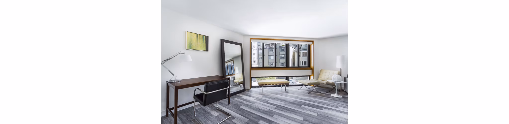 Living room with modern decor and ample natural light at 2000 Broadway Apartments, luxury housing solution by Greystar