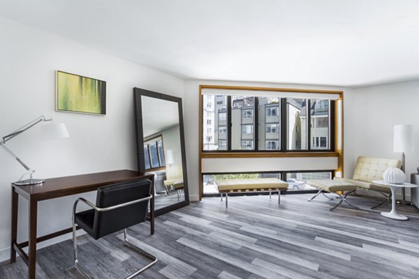 Living room with modern decor and ample natural light at 2000 Broadway Apartments, luxury housing solution by Greystar