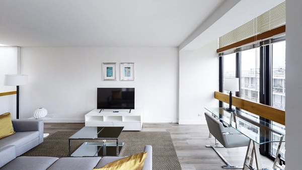 Spacious living room with contemporary furnishings at 2000 Broadway Apartments