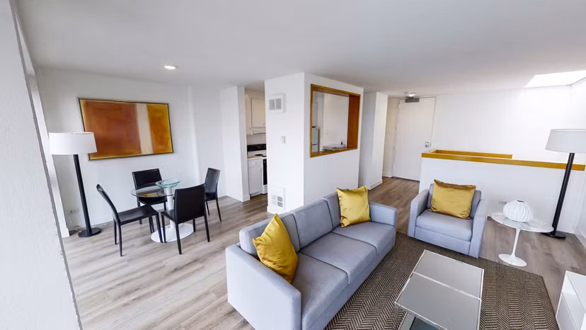 Elegant living room with modern decor and city views in 2000 Broadway Apartments