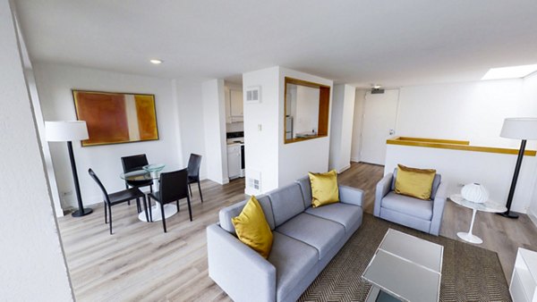 Elegant living room with modern decor and city views in 2000 Broadway Apartments