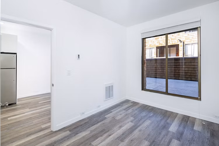Cozy bedroom with modern furnishings at 2133 Stockton Apartments