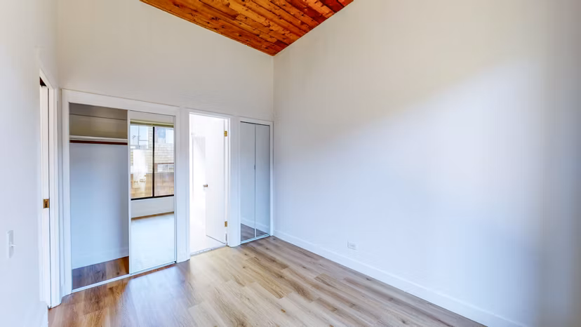 Modern bedroom with stylish decor at 2133 Stockton Apartments featuring luxury finishes and ample natural light