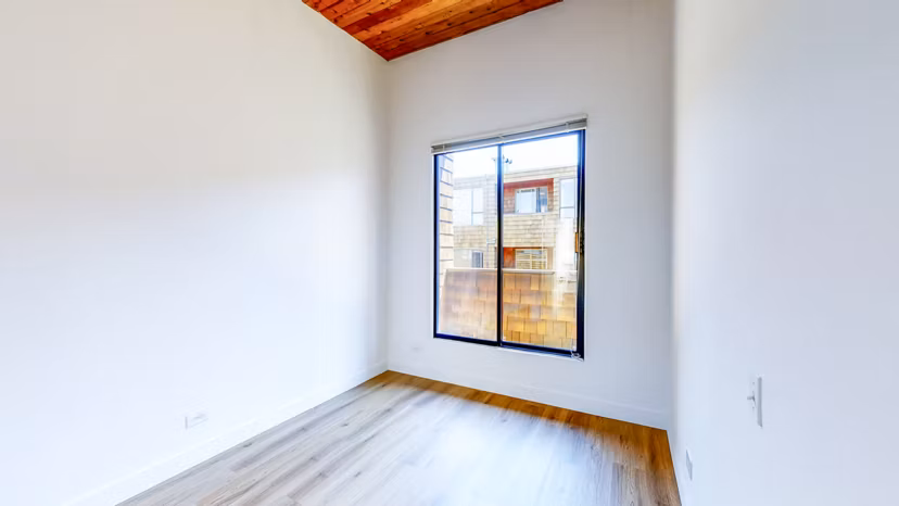 Elegantly furnished bedroom with a modern design at 2133 Stockton Apartments