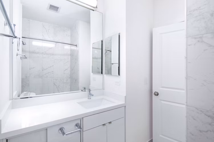 Modern bathroom with marble countertops and sleek fixtures at 2133 Stockton Apartments