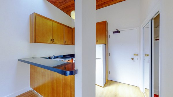 Modern kitchen with sleek countertops and stainless steel appliances at 2133 Stockton Apartments