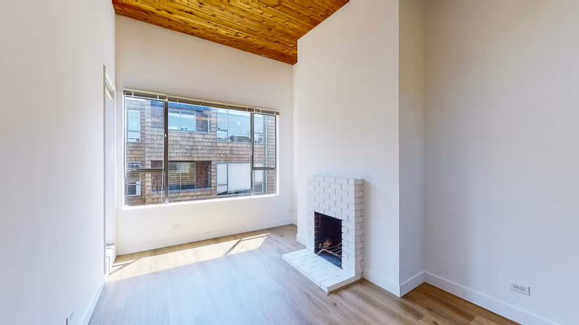 Spacious living room with modern decor and natural light at 2133 Stockton Apartments, showcasing luxury living in the heart of Greystar properties