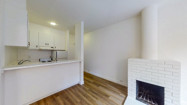 Living room with modern furnishings and large windows at 2133 Stockton Apartments