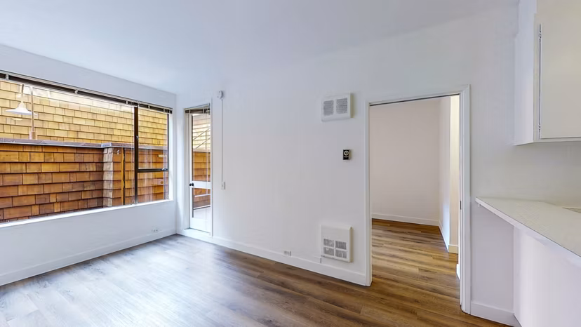 Modern living room with chic decor and ample natural light at 2133 Stockton Apartments