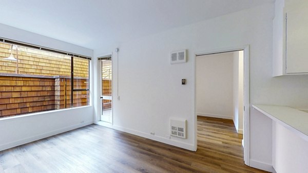 Modern living room with chic decor and ample natural light at 2133 Stockton Apartments