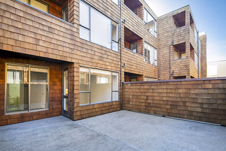 Private patio with stylish seating at 2133 Stockton Apartments, perfect for relaxation and enjoying fresh air in a luxury setting