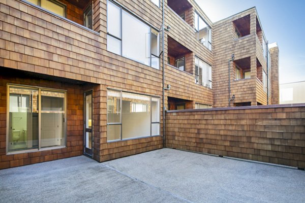 Private patio with stylish seating at 2133 Stockton Apartments, perfect for relaxation and enjoying fresh air in a luxury setting