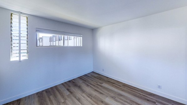 Bedroom featuring modern decor and large windows at 230 Dolores Apartments, a Greystar luxury community in an urban setting