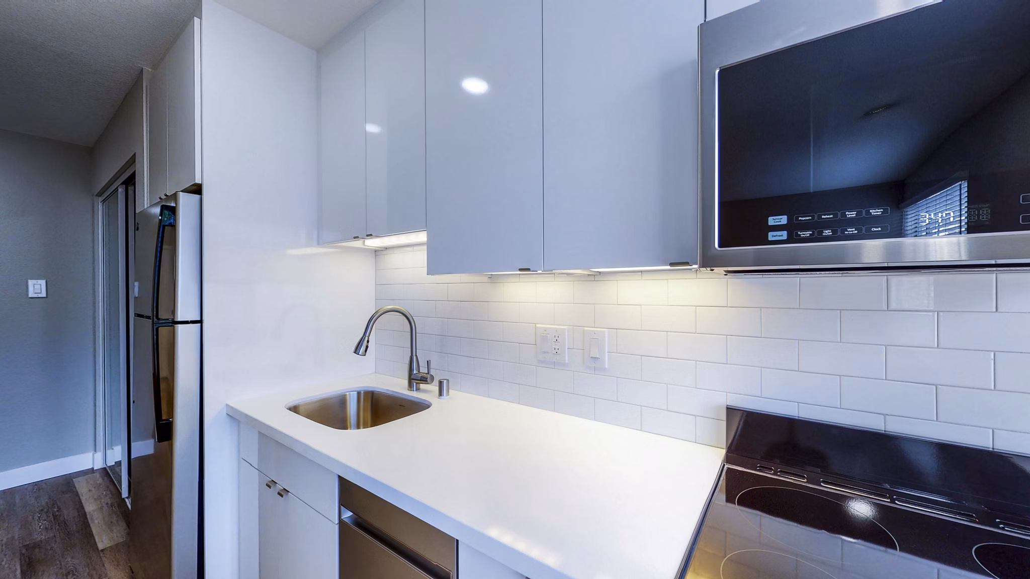 Modern kitchen with stainless steel appliances at 230 Dolores Apartments