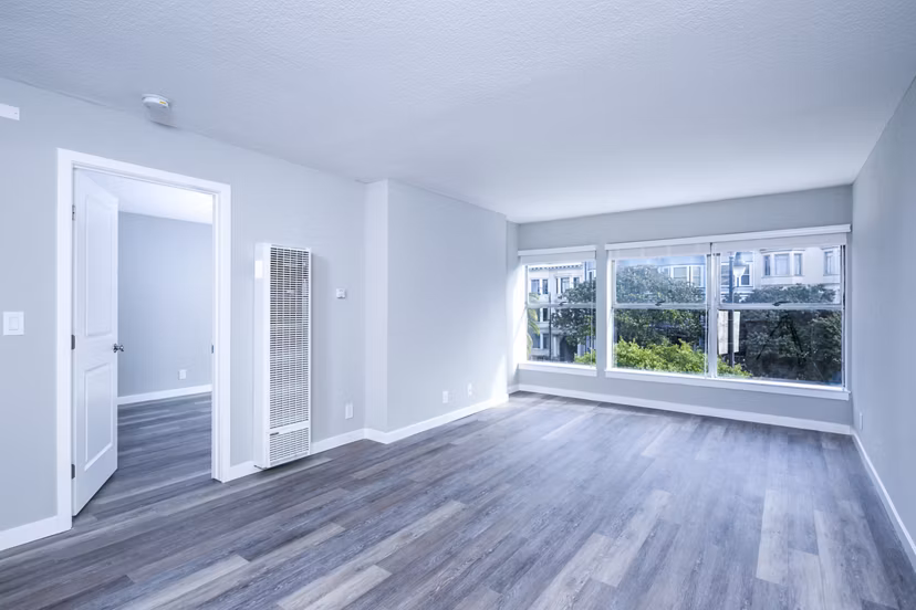 Spacious living room with modern decor and natural light at 230 Dolores Apartments